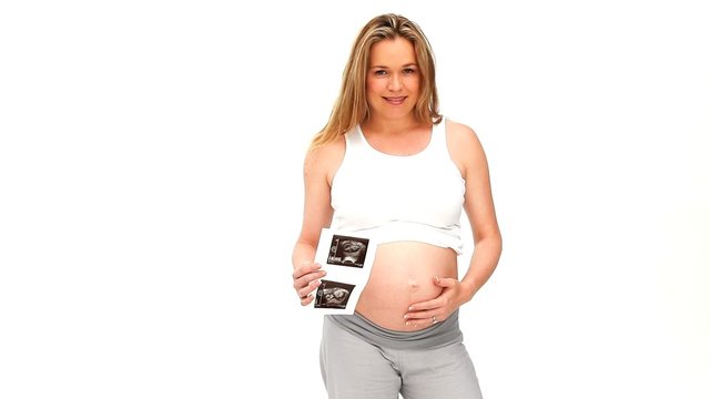 Pregnant woman holding a scan