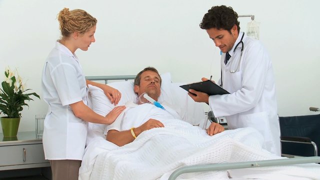 Two doctors visiting a patient
