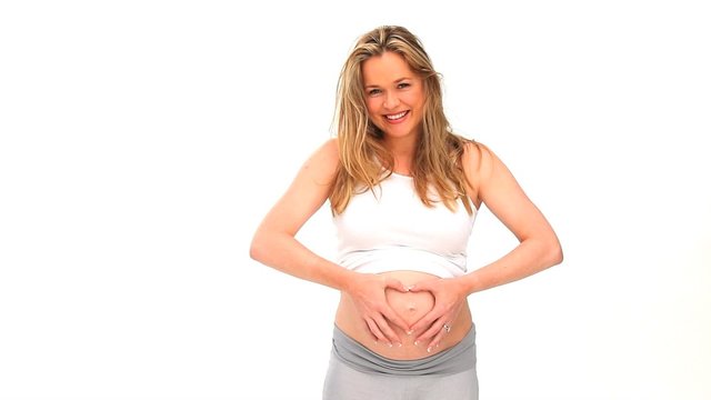 Beautiful expecting woman touching her belly
