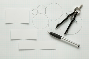 Blank pieces of paper with pen & compass