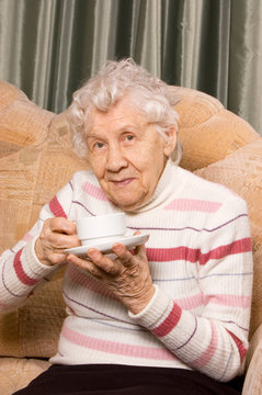 Grandmother from coffee on a sofa
