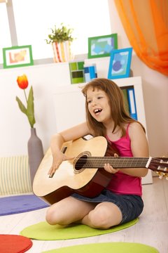 Portrait of schoolgirl with guitar