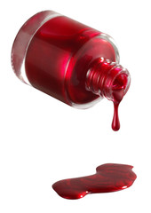 Red nail polish spilling out of the bottle into a puddle
