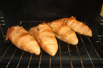 Fresh French croissants in oven