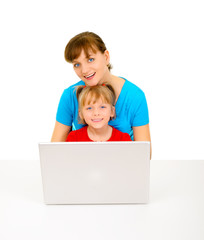 Young pretty mom with daughter and laptop