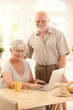 Portrait of senior couple with laptop