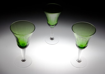 Three green glasses on black and white background