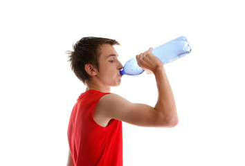 Fototapeta premium Boy teen drinking bottled water after fitness