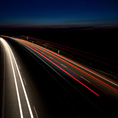 Fototapeta na wymiar Cars moving fast on a highway