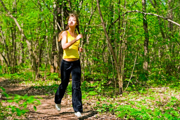 Naklejka na ściany i meble young woman running in park