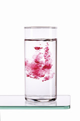 Pouring red syrup in water
