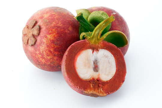 two mangosteens and a half isolated on white
