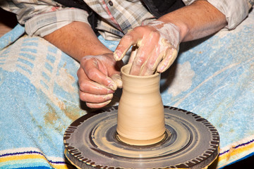 hands working on pottery wheel