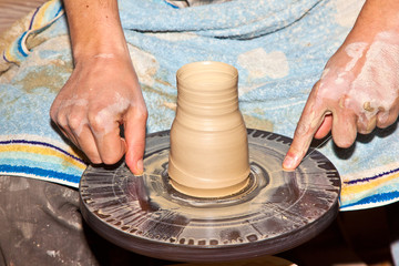 hands working on pottery wheel