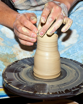 hands working on pottery wheel
