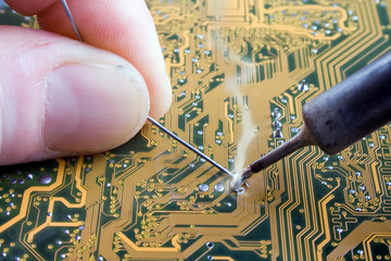 Soldering an electronic circuit - obrazy, fototapety, plakaty
