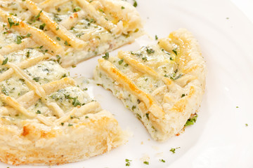 tasty quiche with cheese and herbs
