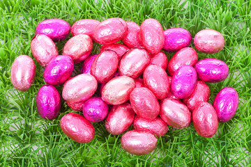 Pink easter eggs on grass