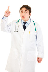 Surprised medical doctor with rised finger. Idea gesture.