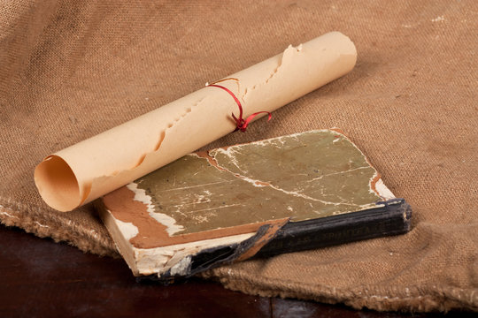Vintage aged book and apper scroll