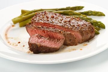 Grilled steak with Green asparagus on white background