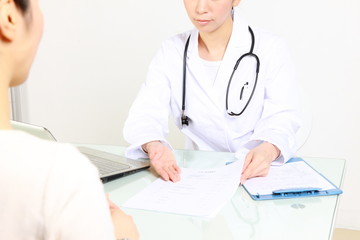 japanese female doctor talks by serious expression with patient