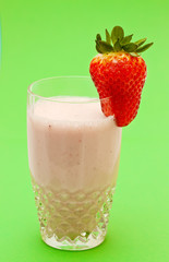 Strawberry milkshake on a green background