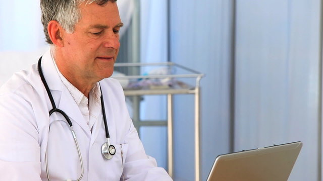 Doctor working on his laptop