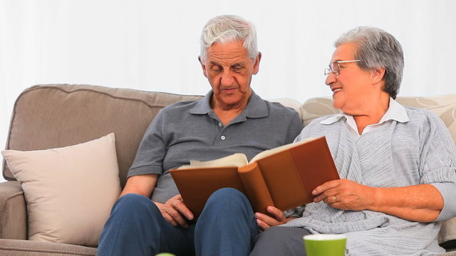 Senior couple looking at their photo album