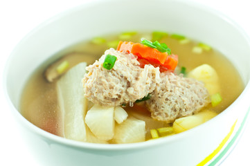 Vegetable soup with pork in white bowl