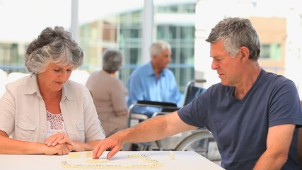 Couple playing dominos - Powered by Adobe