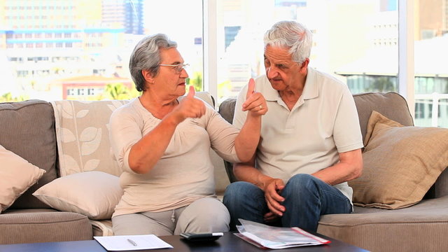 Mature couple calculating their domestics bills