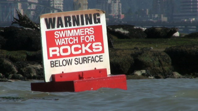 Swimmers Watch For Rocks
