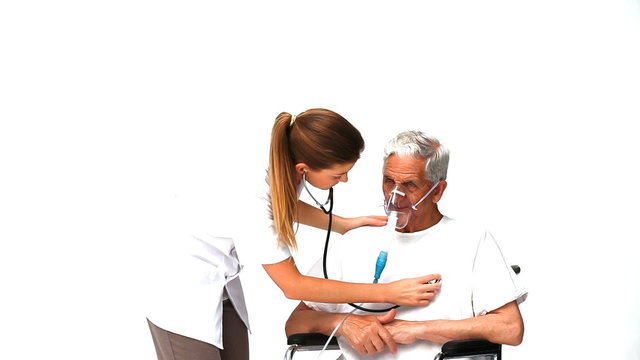Nurse taking the hearbeat of her sick patient