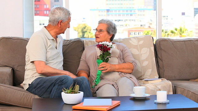 Elderly couple with flowers