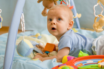 baby playing on blanket