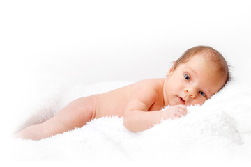 Newborn baby laying on the white blanket