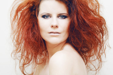Obraz premium Young fashion model with curly red hair.