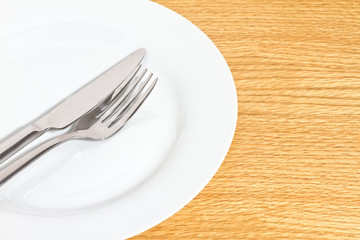 Knife and fork on white plate