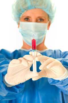 woman surgeon holding a syringe
