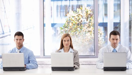 Young businesspeople with laptops