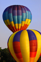 Two hot air balloons in the sky in dusk