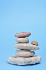 Fototapeta na wymiar zen stones on a blue background