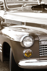 Classic car front end in sepia color tone