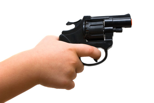 Child hand holding a toy gun