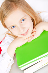 small girl with books on table