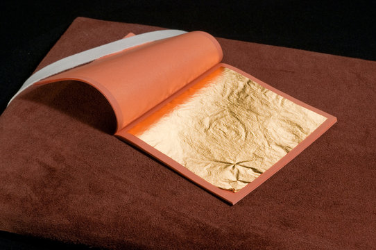 a booklet of pure gold leaf for gilding with craftsman's tools