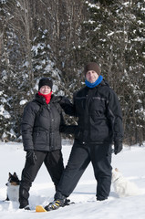 Fototapeta na wymiar young man and woman in snowshoes
