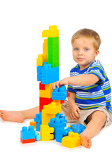 Cute little boy is playing with building blocks
