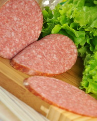 Appetizing boiled-smoked sausage with green salad